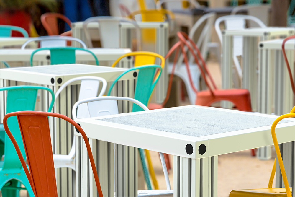 Kleurrijke stoelen met beton-look tafels